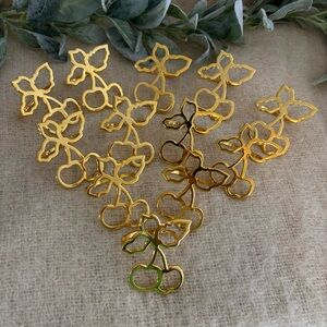 Set of 12 gold tone napkin rings shaped like cherries